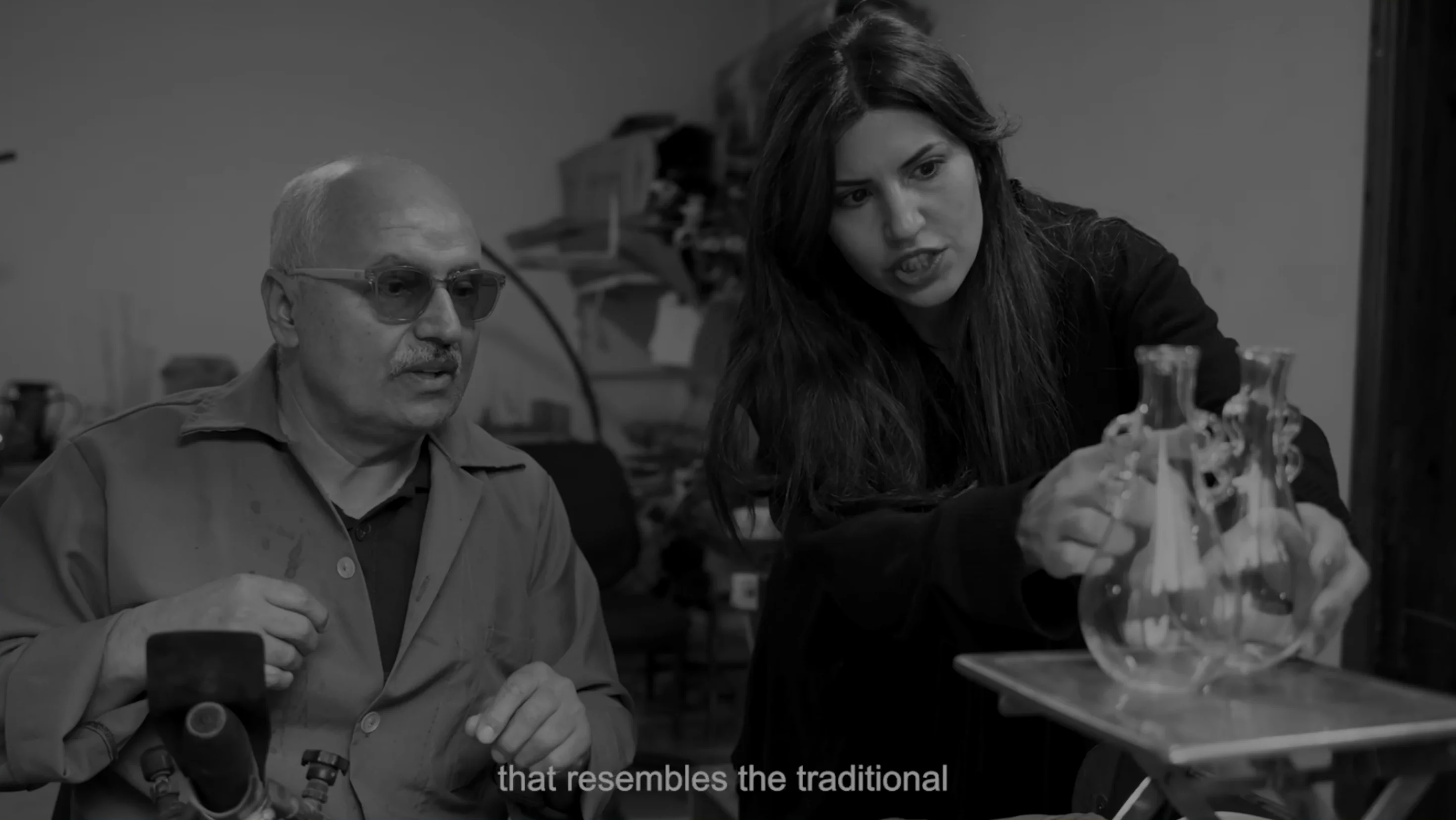 Artisans examining a hand-blown vessel (video)